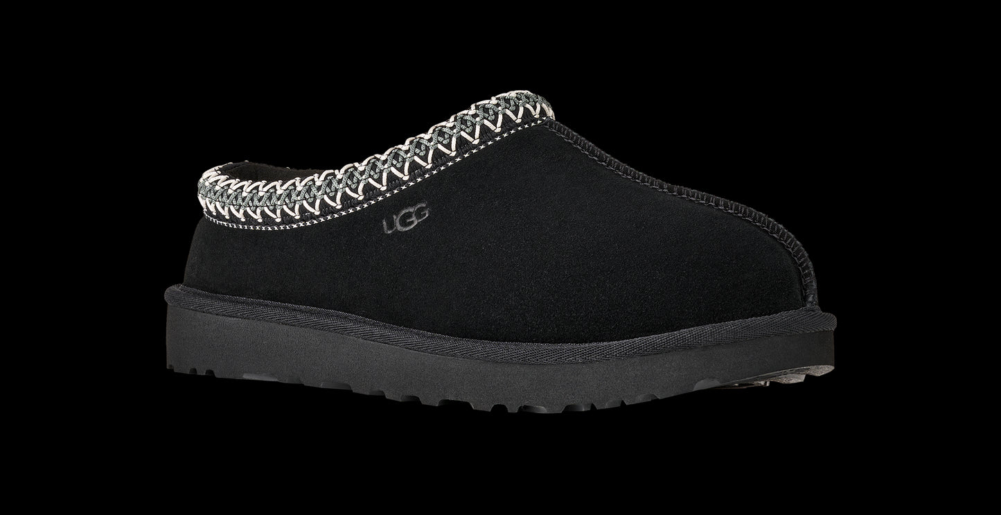 Black slip-on shoe with patterned trim on a white background
