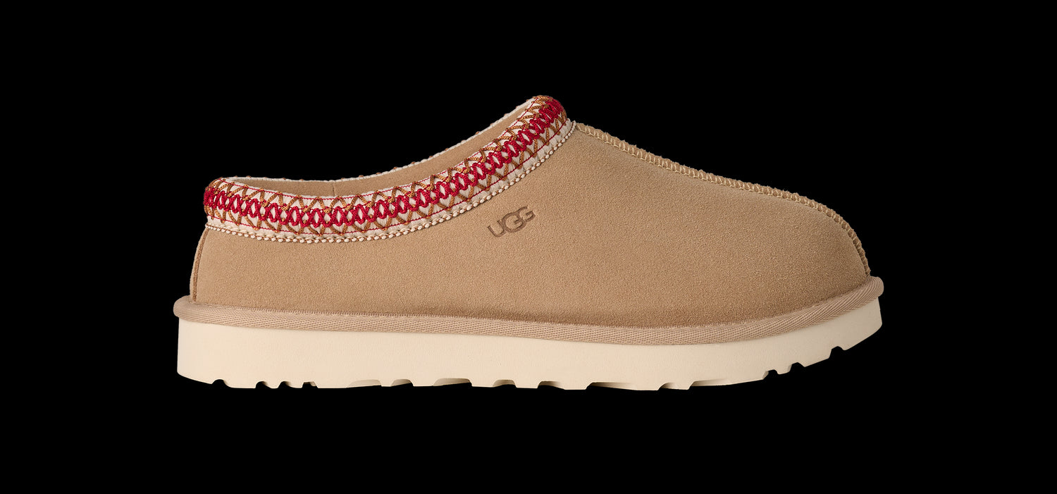 Tan slipper with red trim on a white background