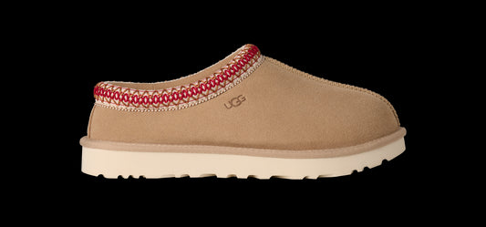 Tan slipper with red trim on a white background