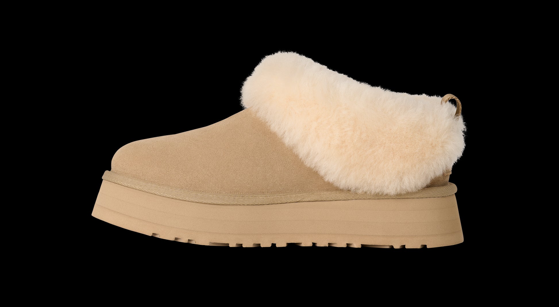 Beige slipper with white fur lining on a white background