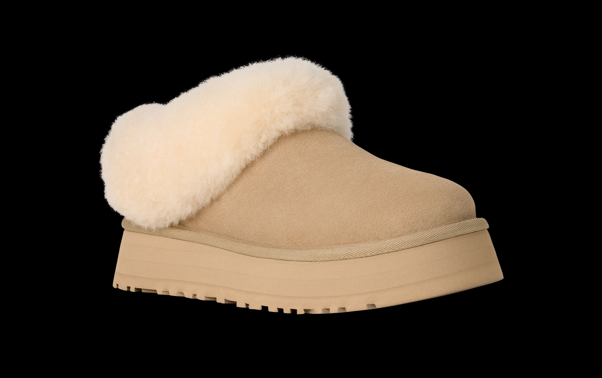 Tan slipper with white fur lining on a white background