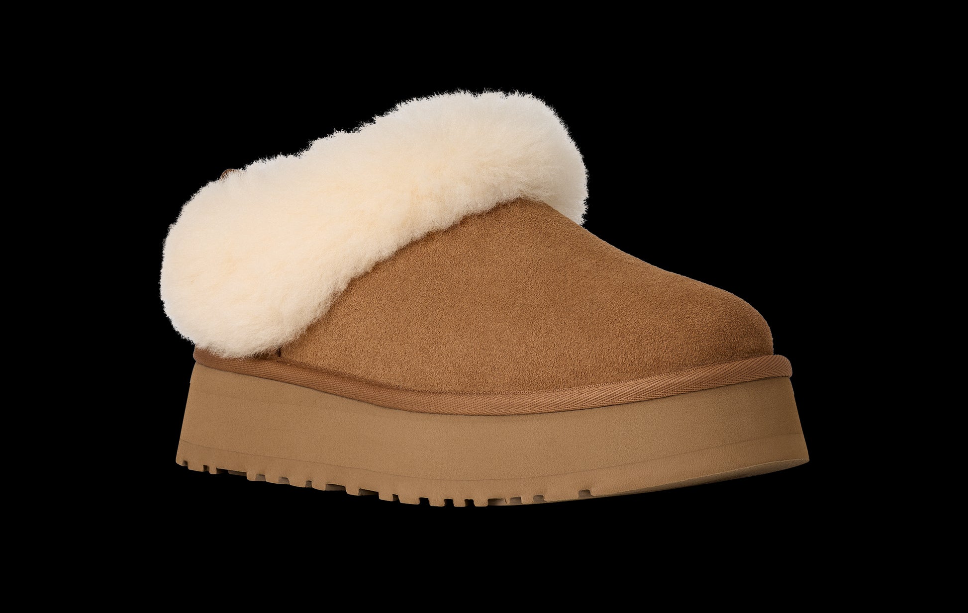 Brown slipper with white fur lining on a white background