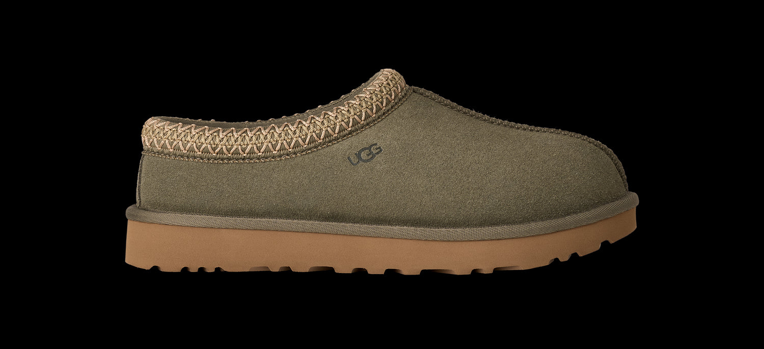 Green slipper with brown sole on a white background